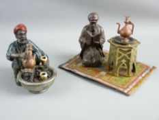 TWO MODERN BERGMAN STYLE CAST & PAINTED FIGURINES, one depicting a Northern African man squatting