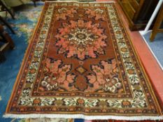 AN IRANIAN MOSSUL WOVEN WOOL CARPET, red ground with central floral pattern and multi-bordered edge,