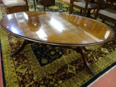 AN EXCELLENT REPRODUCTION MAHOGANY OVAL TOPPED COFFEE TABLE on a twin pedestal base with turned