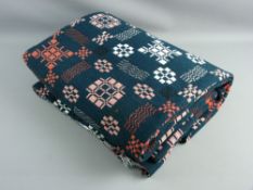 A TRADITIONAL WELSH WOOLLEN BLANKET with 'Holytex' label, in dark green with red and white woven