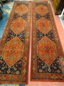 A PAIR OF RED GROUND BELGIAN RUNNER CARPETS, Orient Express, 100% wool pile by Prado, 268 x 68 cms