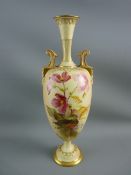 A ROYAL WORCESTER HAND PAINTED TWIN HANDLED VASE having floral decoration on a blush ground with