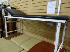 A MEDICAL/PHYSIO COUCH - a black wipe down upholstered fixed height couch with adjustable head