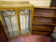 A VINTAGE WALNUT TWO DOOR CHINA DISPLAY CABINET and a mahogany open waterfall type bookcase, 121 x