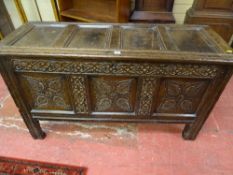 AN 18th CENTURY OAK DOWER CHEST, the four panel lift-up top with shaped moulding and rounded edging,