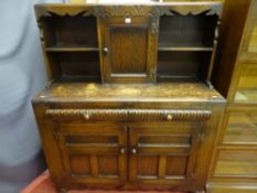A CIRCA 1930's CARVED OAK SIDEBOARD with shelf and central cupboard door top, twin frieze drawers