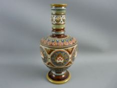 A METTLACH STONEWARE VASE on a treacle glazed ground and colourful decoration in relief, impressed
