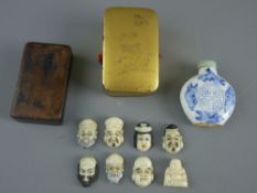 A JAPANESE GILT LACQUERED LIDDED BOX containing seven Ojime and a small figure of Budai, a snuff box