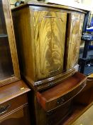 Chest on chest style cabinet with two upper doors and four lower base drawers with slider