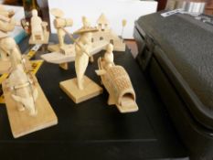 Series of carved Oriental figures with accompanying craftmaker's tools