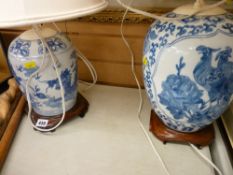 Two excellent blue and white Oriental vases on hardwood stands (converted to lamps)