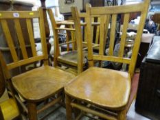 Four matching wooden chairs with slatbacks