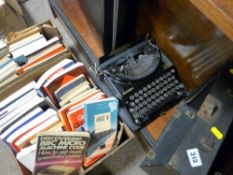 Old Remington portable typewriter in a case, a briefcase and a quantity of computing literature etc