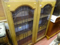 Pair of wooden kitchen units with glazed doors