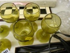 Set of six green glass goblets and a glass lidded powder bowl