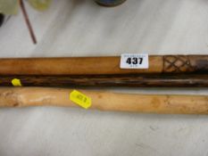 Three carved walking sticks