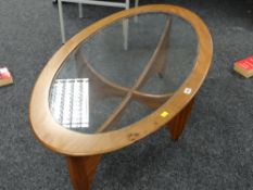 A vintage G-plan oval glass topped coffee table