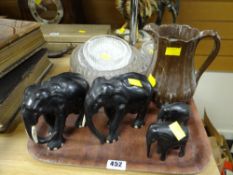 Four carved wooden elephant figures, lustre jug, Dartington 'Sunflower' glass plate etc