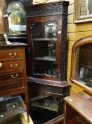 Early twentieth century mahogany glass door standing corner cupboard with decoration to top & sides