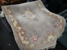 A fawn patterned Chinese washed rug