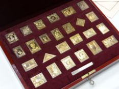 A cased set of twenty-five gold plated solid silver Empire Collection stamps