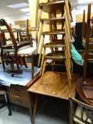 A vintage Ercol drop leaf dining table together with six triangle backed Ercol chairs