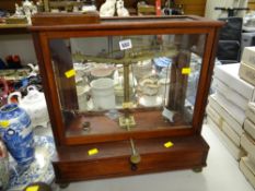 A cased chemist shop weighing scales together with a Morse code communicator