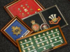 Collection of cased insignia, helmet badge, embroidered badges relating to the Welsh Regiment