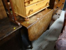 An antique oak drop leaf dining table