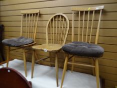 A pair of Ercol spindle back kitchen chairs together with another