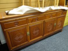 An Oriental hardwood & carved decorated sideboard