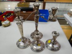 Candelabra, pair of small candlesticks together with another candlestick, white metal believed to be