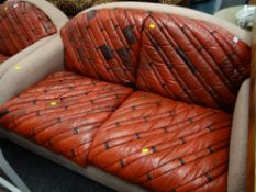 A vintage patched leather cushioned & upholstered arch back cottage suite comprising two-seater sofa