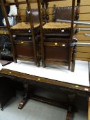 A vintage extending oak dining table together with four leather & studded cushioned dining chairs