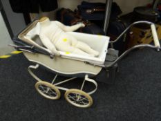 A vintage Restmor child's sprung pram together with a child mannequin