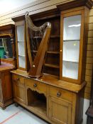 Early twentieth century light oak dresser with central shelving flanked by single glass door