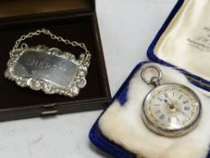 Hallmarked silver ladies' fob watch together with a hallmarked silver decanter label