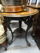 A vintage wooden topped & cast iron based pub table