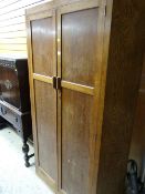 A vintage light oak shaped front two-door wardrobe