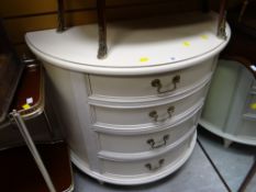A modern white painted four-drawer demi-lune chest of drawers