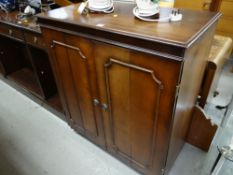 Reproduction mahogany narrow bookcase with three drawers together with a reproduction mahogany TV