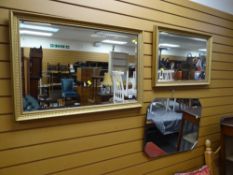 Two modern gilt framed bevelled wall mirrors together with another