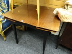 A vintage mahogany & ebonized legged extending dining table