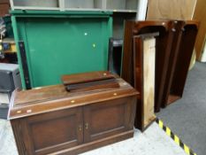 A mahogany bookcase fronted locking gun cabinet mounted on a cupboard base