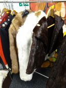 A fox fur short jacket together with two other fur jackets