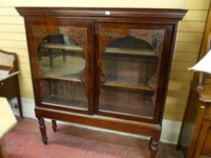 A GOOD VICTORIAN MAHOGANY SLIDING DOOR BOOKCASE on stand with inverted step cornice, twin glazed