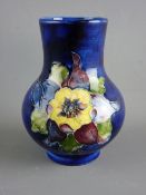 A MOORCROFT 'COLUMBINE' 10.75 cms HIGH BULBOUS VASE decorated on a cobalt ground, having impressed