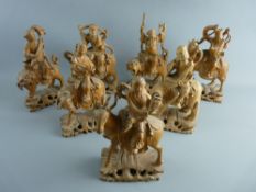 SEVEN WELL CARVED CHINESE SANDALWOOD FIGURES depicting various Gods mounted on mythical beasts on