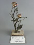 AN ALBANY FINE CHINA GOLDFINCH, bronze and porcelain study of two birds perched on branches and