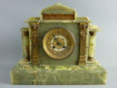 A HEAVY ONYX MANTEL CLOCK with brass dial, 29 cms high, 35 cms wide, 14 cms deep